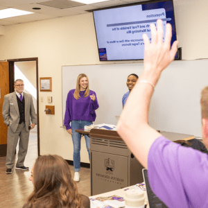 Students presenting in class and answering a question